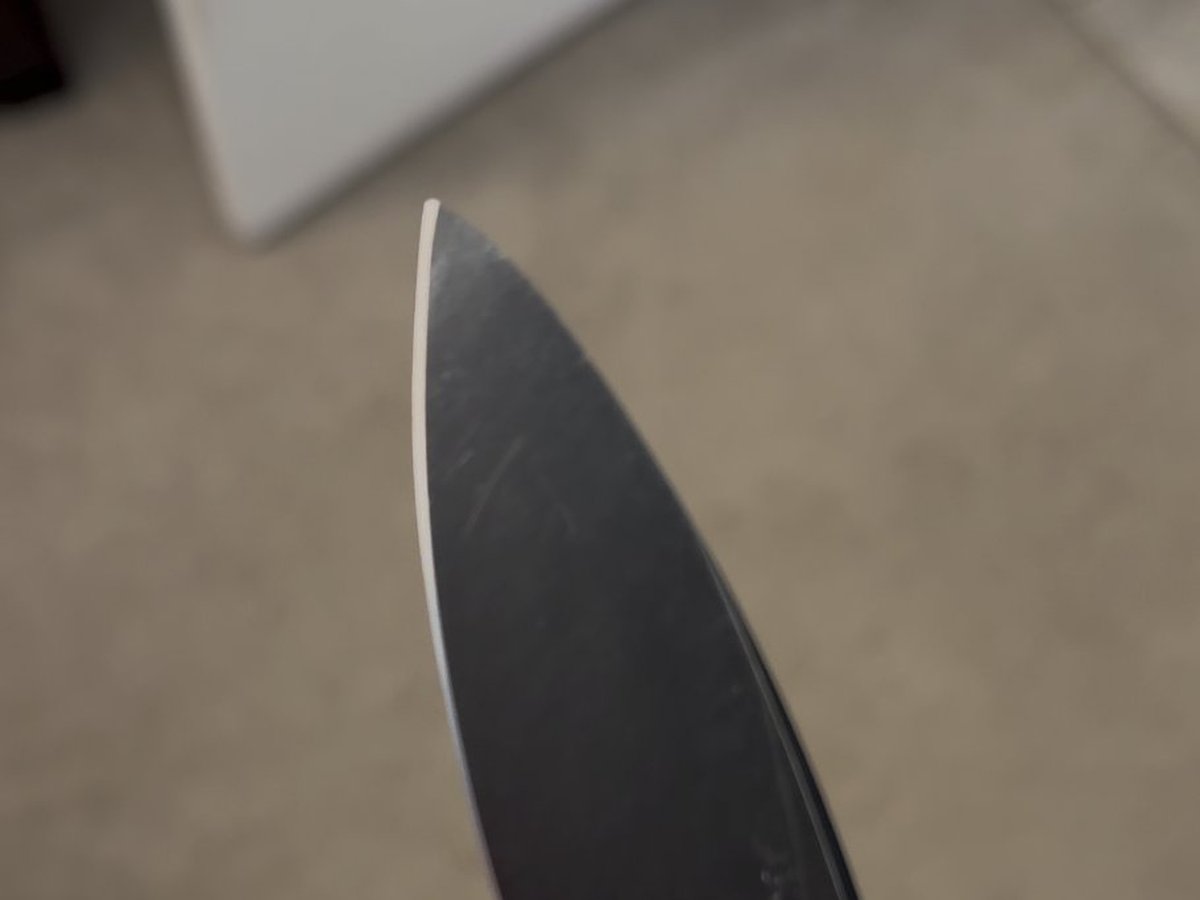 Same knife with restored sharp tip and freshly exposed cutting edge — after sharpening