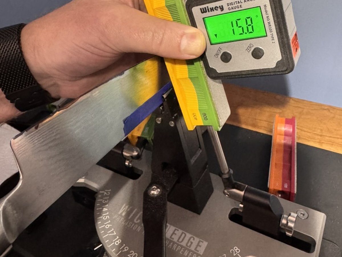 Damascus blade in WickedEdge Pro with digital gauge confirming 15.8 degree bevel angle